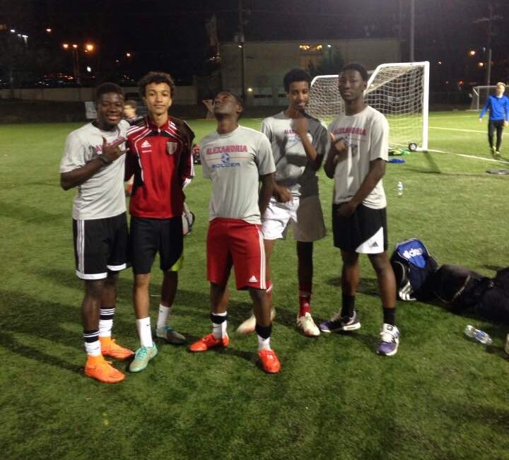 Sam, on the far left in his orange soccer cleats, poses at Witter with his ASA teammates!